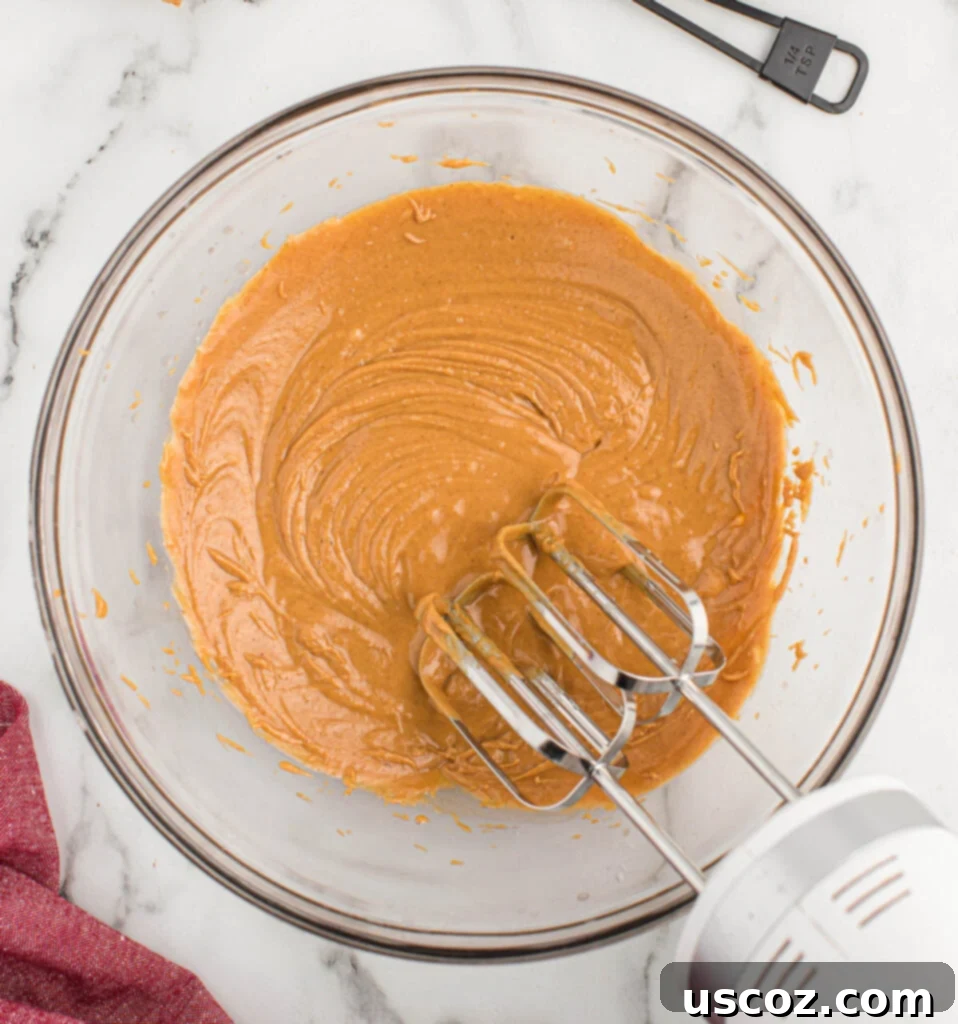 No-Bake Peanut Butter Graham Bites 5 Peanut butter in a mixing bowl, ready to be combined with other ingredients.