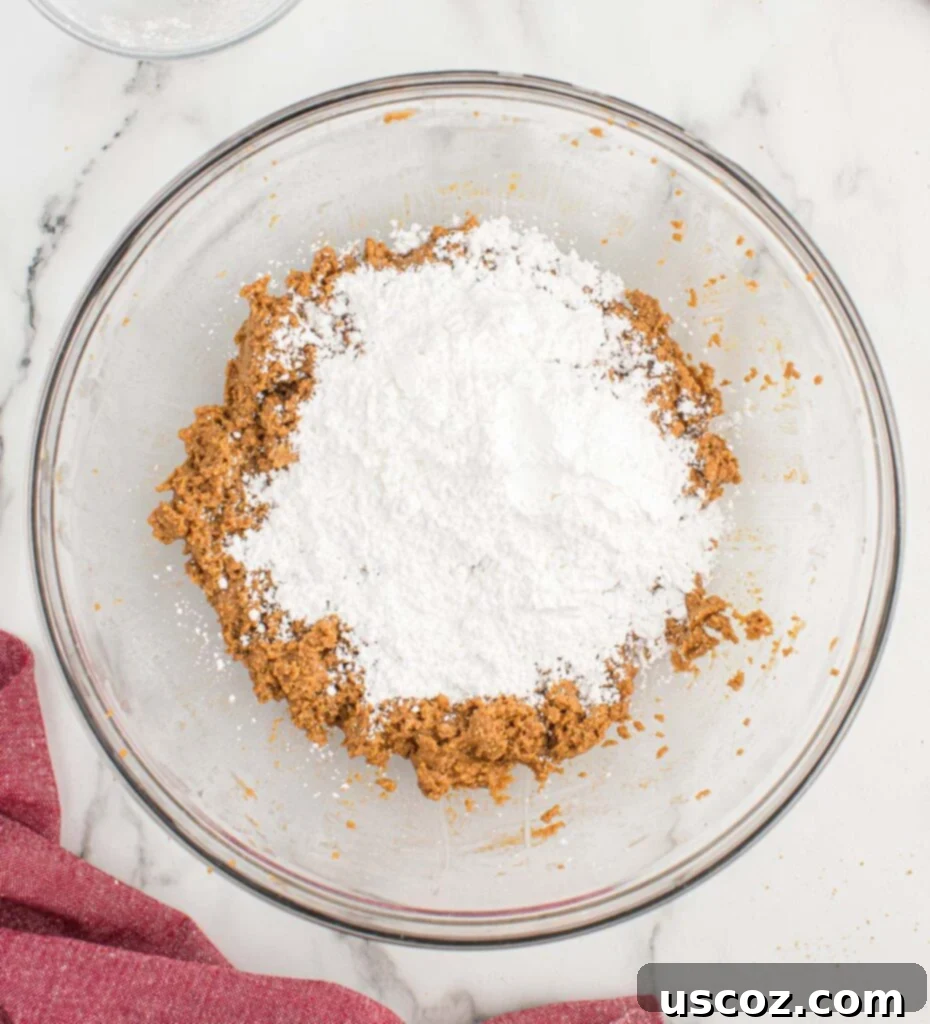 No-Bake Peanut Butter Graham Bites 9 Adding powdered sugar to the peanut butter mixture.