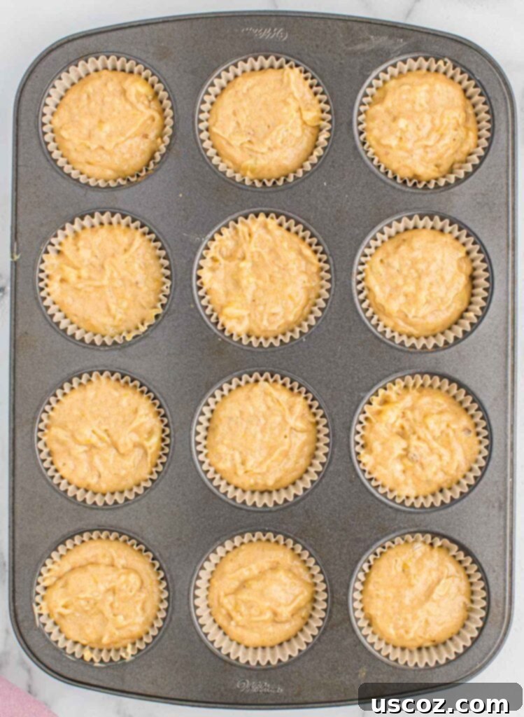 Foolproof Banana Bread Muffins 10 muffin tin filled with banana bread batter