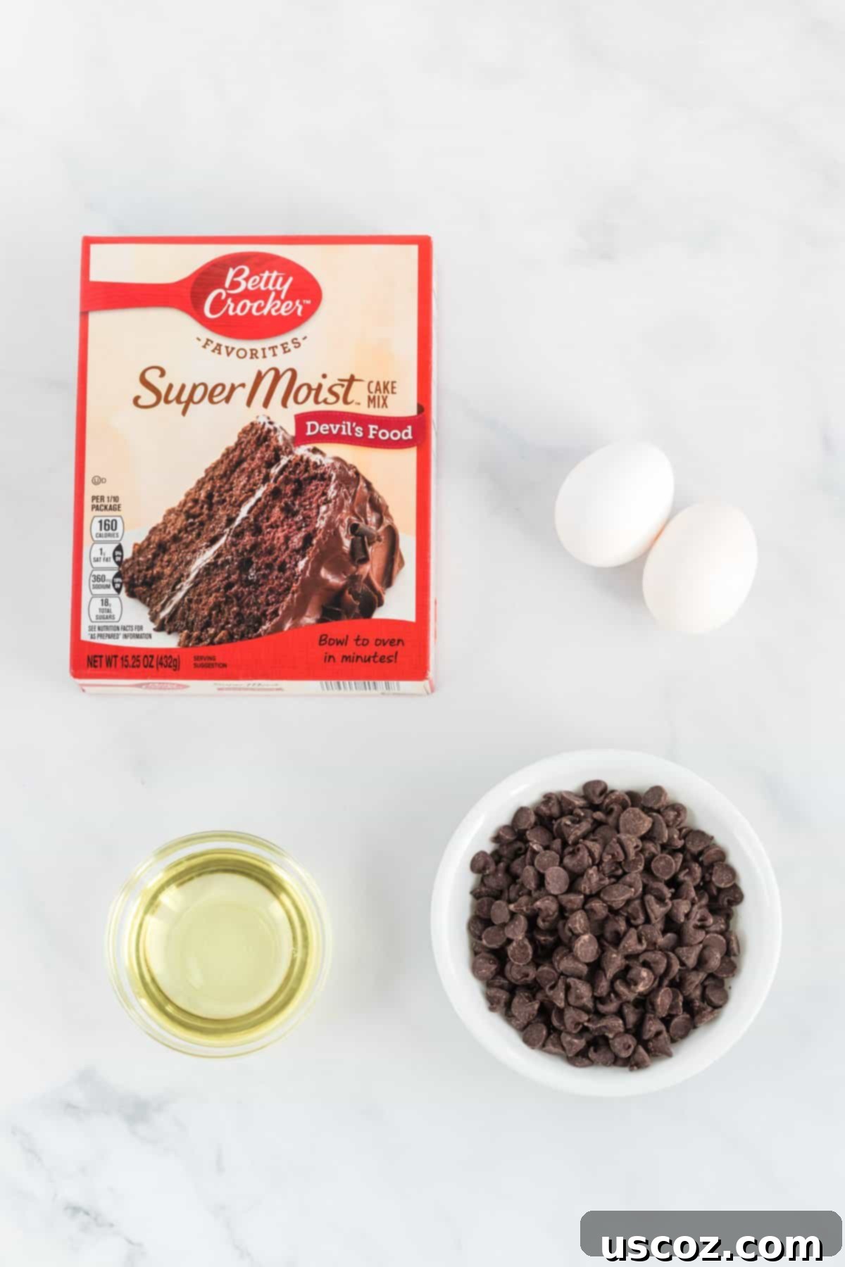 Simple Cake Mix Delights 4 Key ingredients for cake mix cookies laid out: a box of yellow cake mix, two eggs, a bottle of vegetable oil, and a bowl of chocolate chips.
