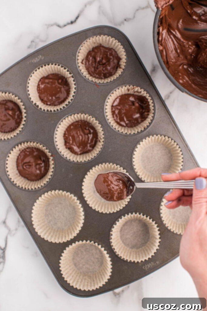 Homemade Peanut Butter Cups 6 spooning melted chocolate into parchment paper muffin liners