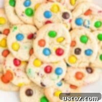 Fluffy White Cake Mix Cookies 15 m&m cookies on a white plate