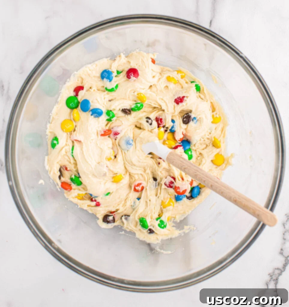 Fluffy White Cake Mix Cookies 7 The cake mix cookie batter, now studded with M&M's, ready for scooping.