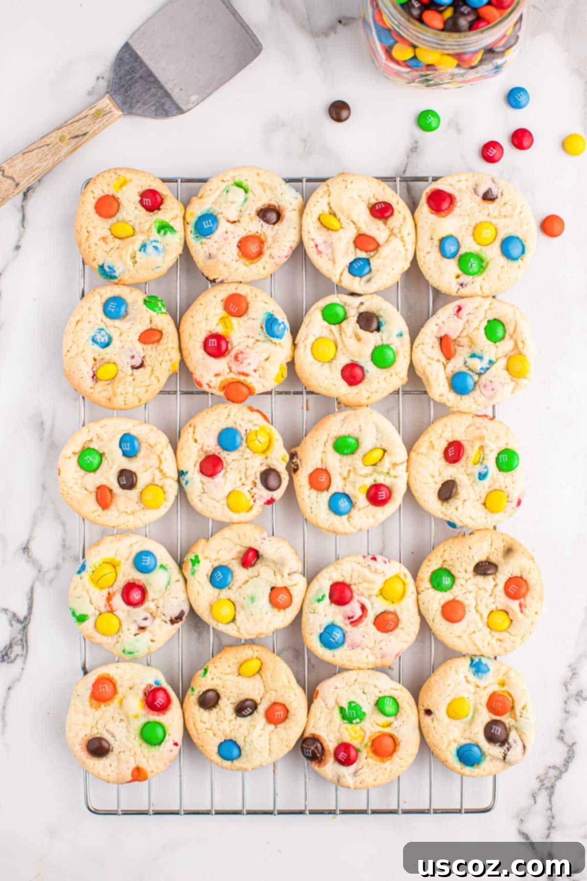 Fluffy White Cake Mix Cookies 10 Freshly baked white cake mix cookies resting on a wire cooling rack, allowing them to cool and set.