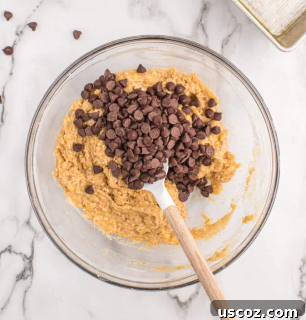 The Ultimate Chocolate Chip Banana Bread 7 Stirring chocolate chips into banana bread batter