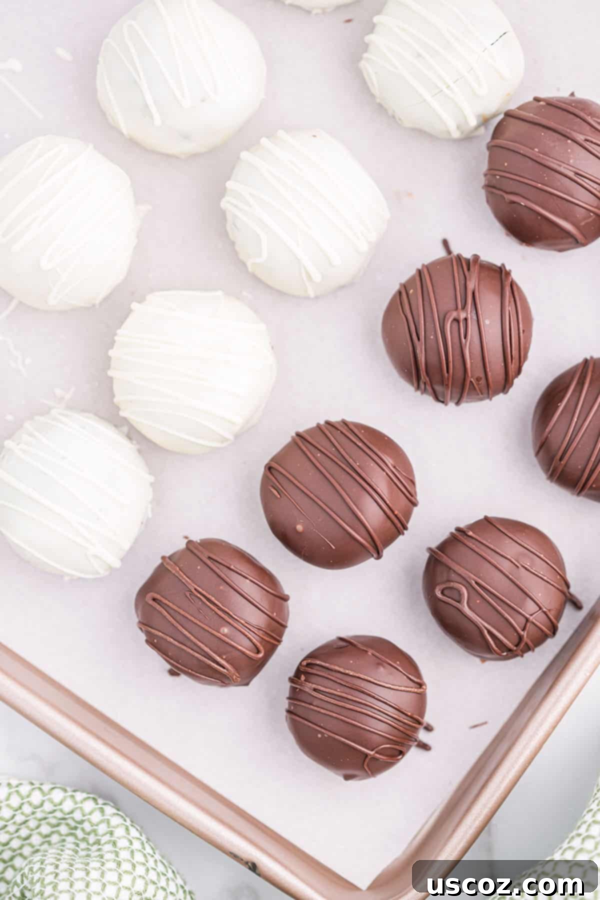 Minty Oreo Truffle Bites 14 oreo truffles on a baking sheet arranged for photography