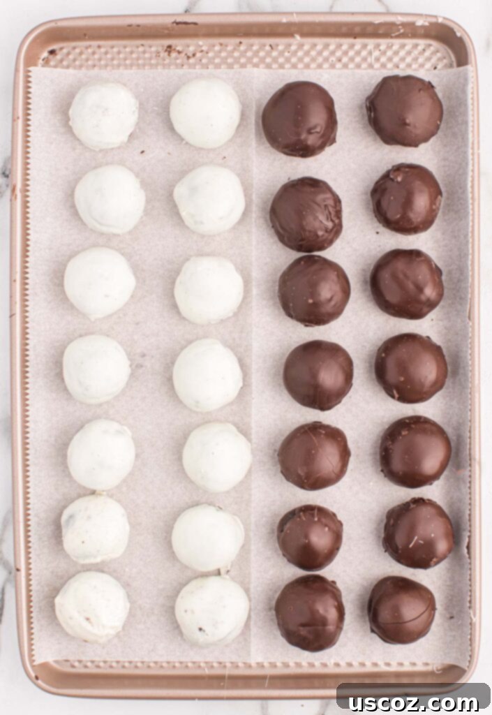 Minty Oreo Truffle Bites 10 oreo balls on a baking sheet with drizzles