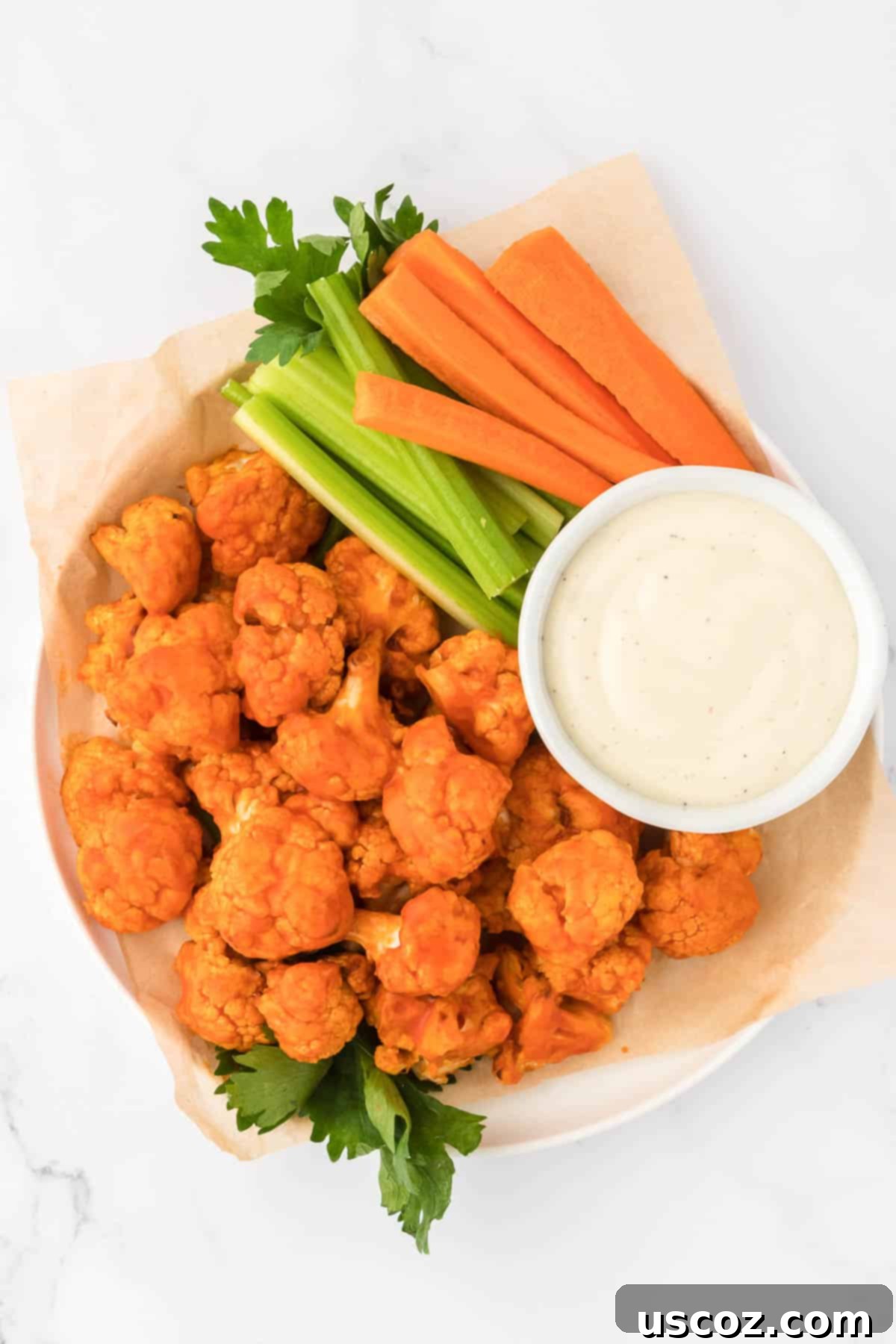 Air Fryer Buffalo Cauliflower Wings 2 buffalo cauliflower bites with celery, carrots, and ranch