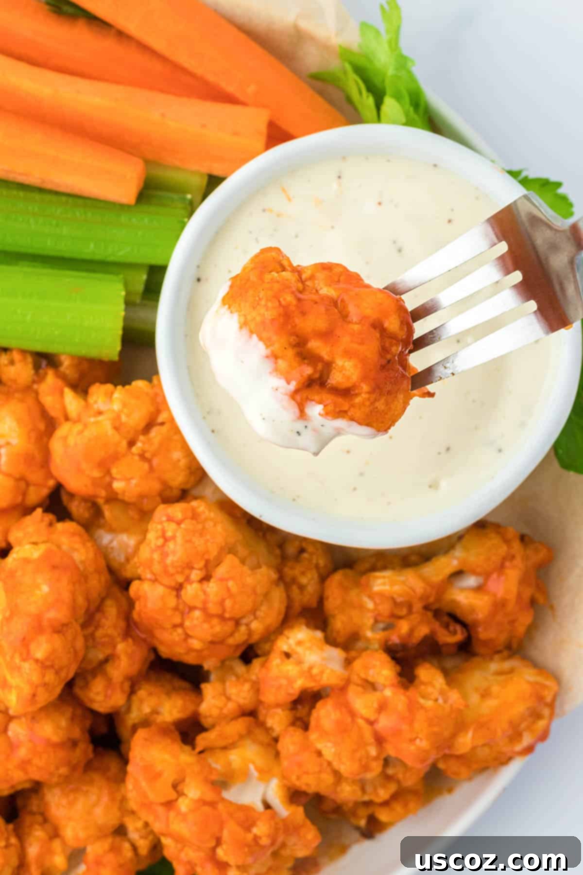 Air Fryer Buffalo Cauliflower Wings 3 dipping buffalo cauliflower into ranch