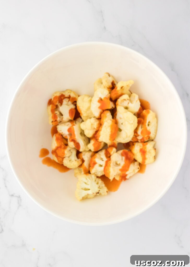 Air Fryer Buffalo Cauliflower Wings 10 buffalo sauce over cauliflower in a bowl