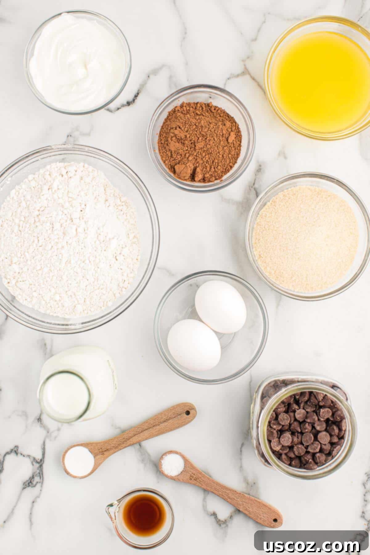 Ultimate Double Chocolate Muffins 4 ingredients needed to make chocolate muffins laid out on a table