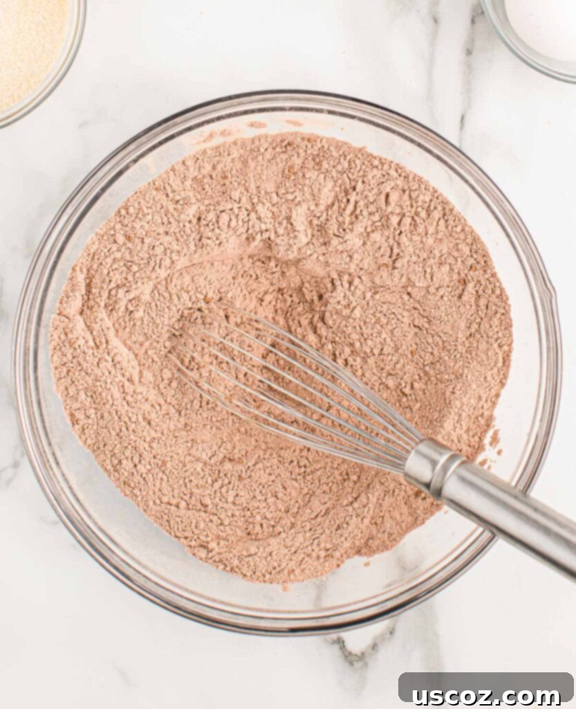 Ultimate Double Chocolate Muffins 5 dry ingredients mixed together in a bowl, showing flour and cocoa