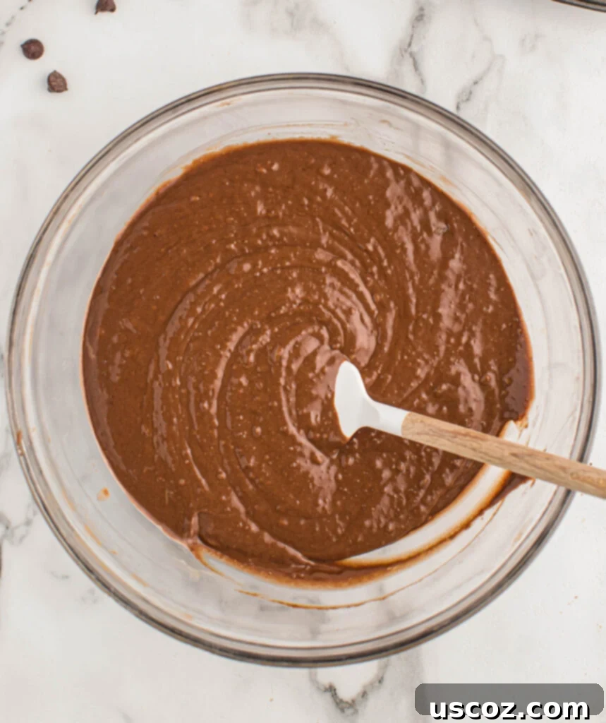 Ultimate Double Chocolate Muffins 7 chocolate muffin batter in a bowl, perfectly mixed