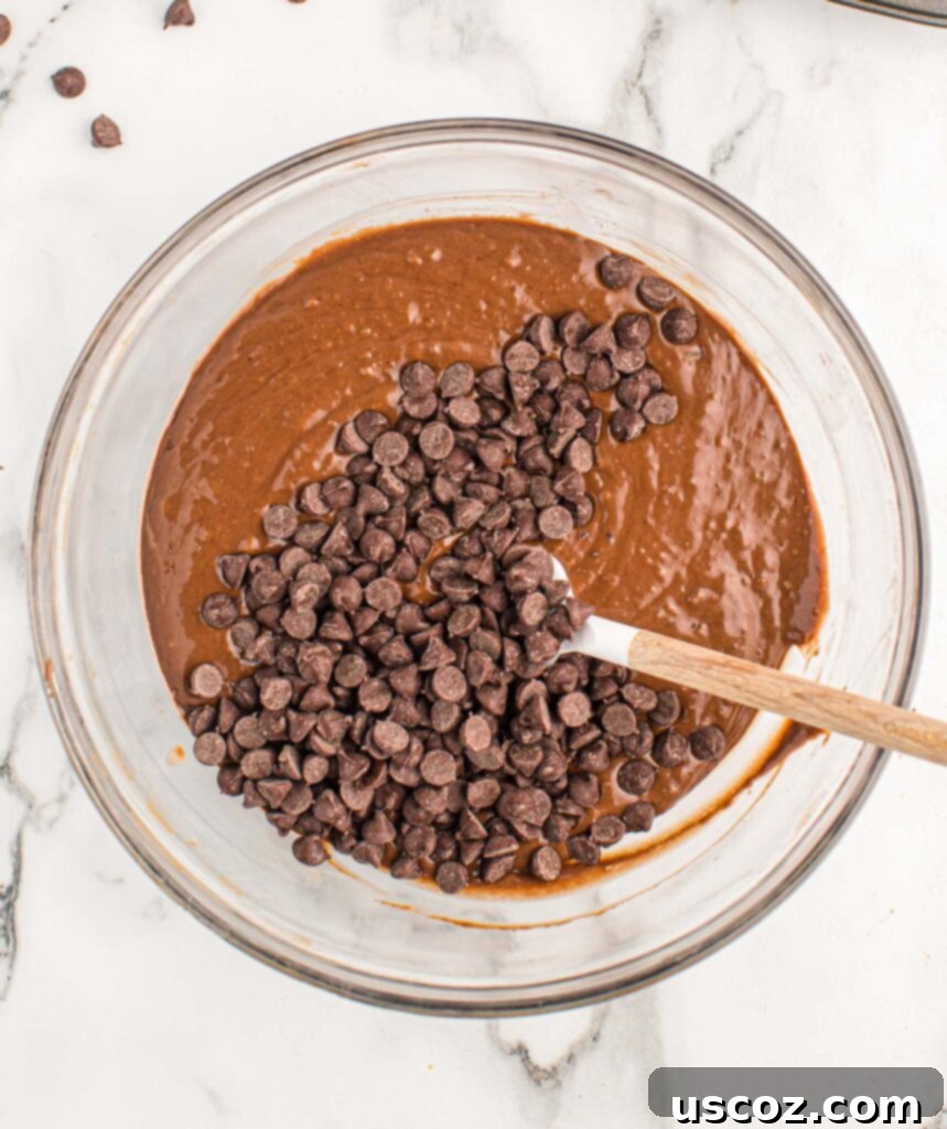 Ultimate Double Chocolate Muffins 8 adding chocolate chips to the chocolate muffin batter