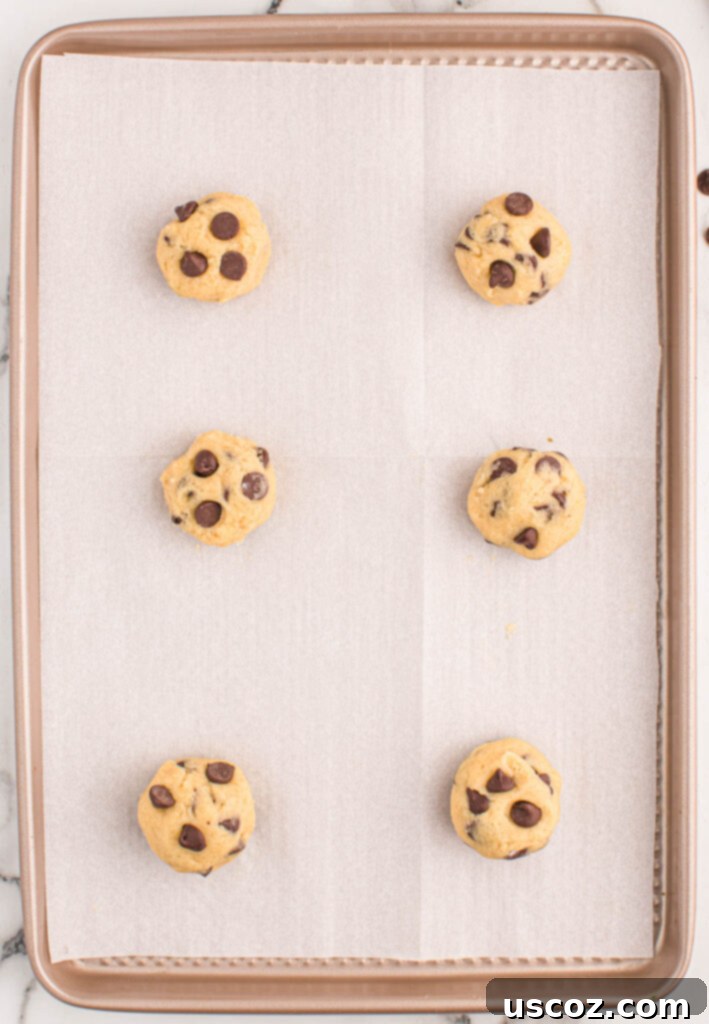 Golden Crisp Chocolate Chip Cookies 16 chocolate chip cookie dough batter on a baking sheet before baking