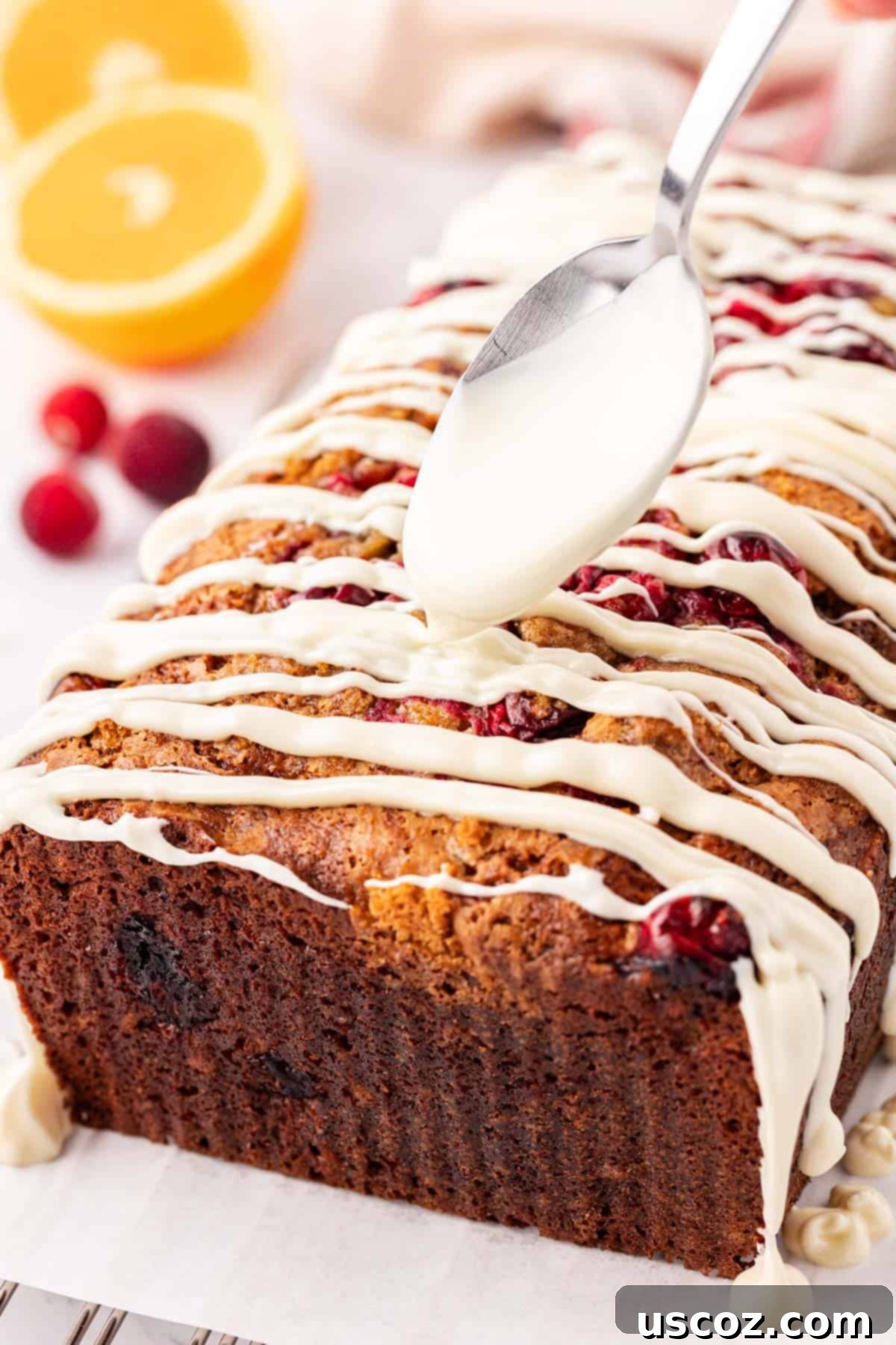 Festive Cranberry Eggnog Bread 15 whole cranberry eggnog bread on a cutting board, garnished
