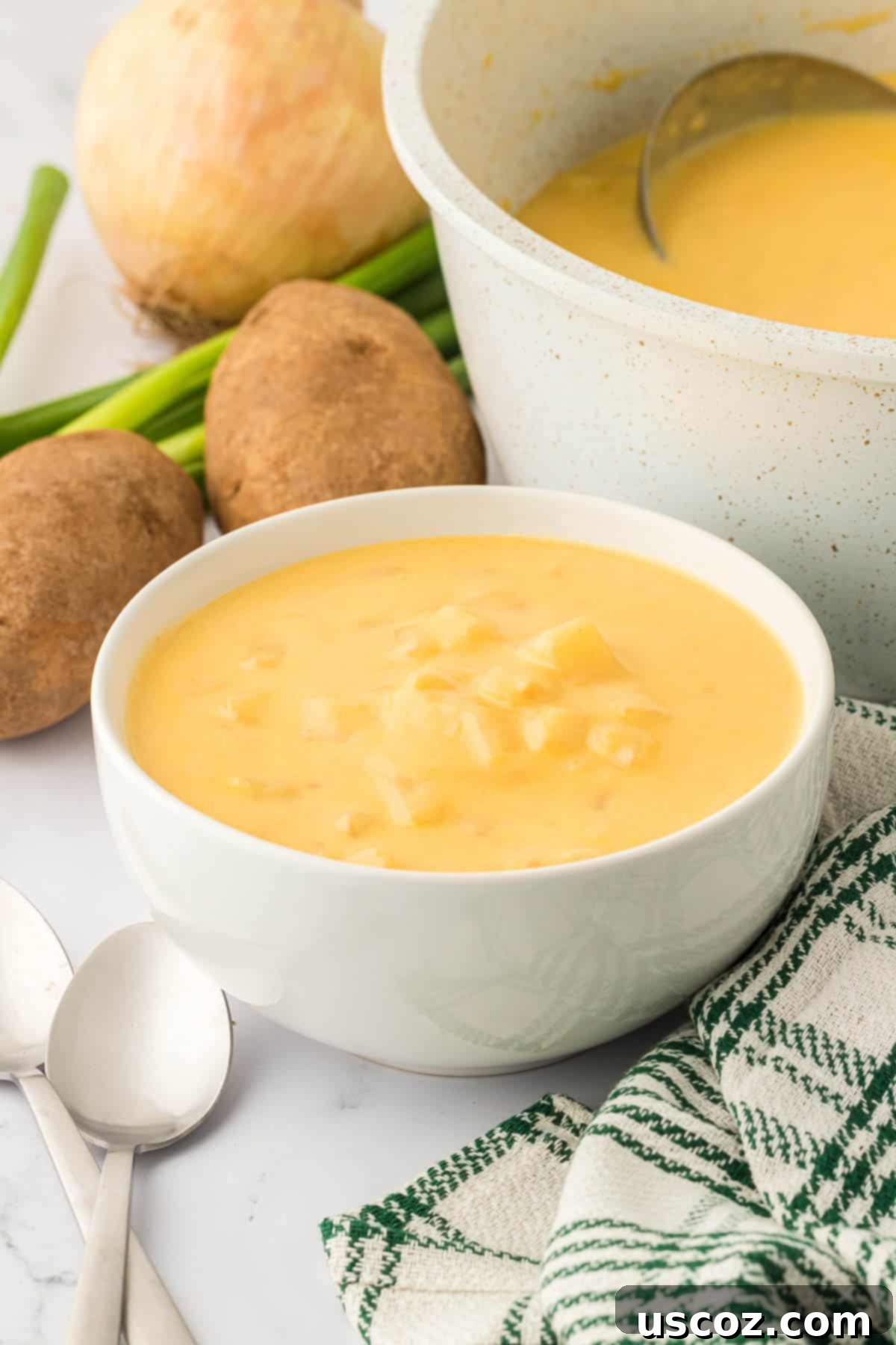Hearty Potato Comfort 17 A close-up of a bowl of potato soup, showcasing its creamy texture, with a spoon resting in it, ready for a taste.