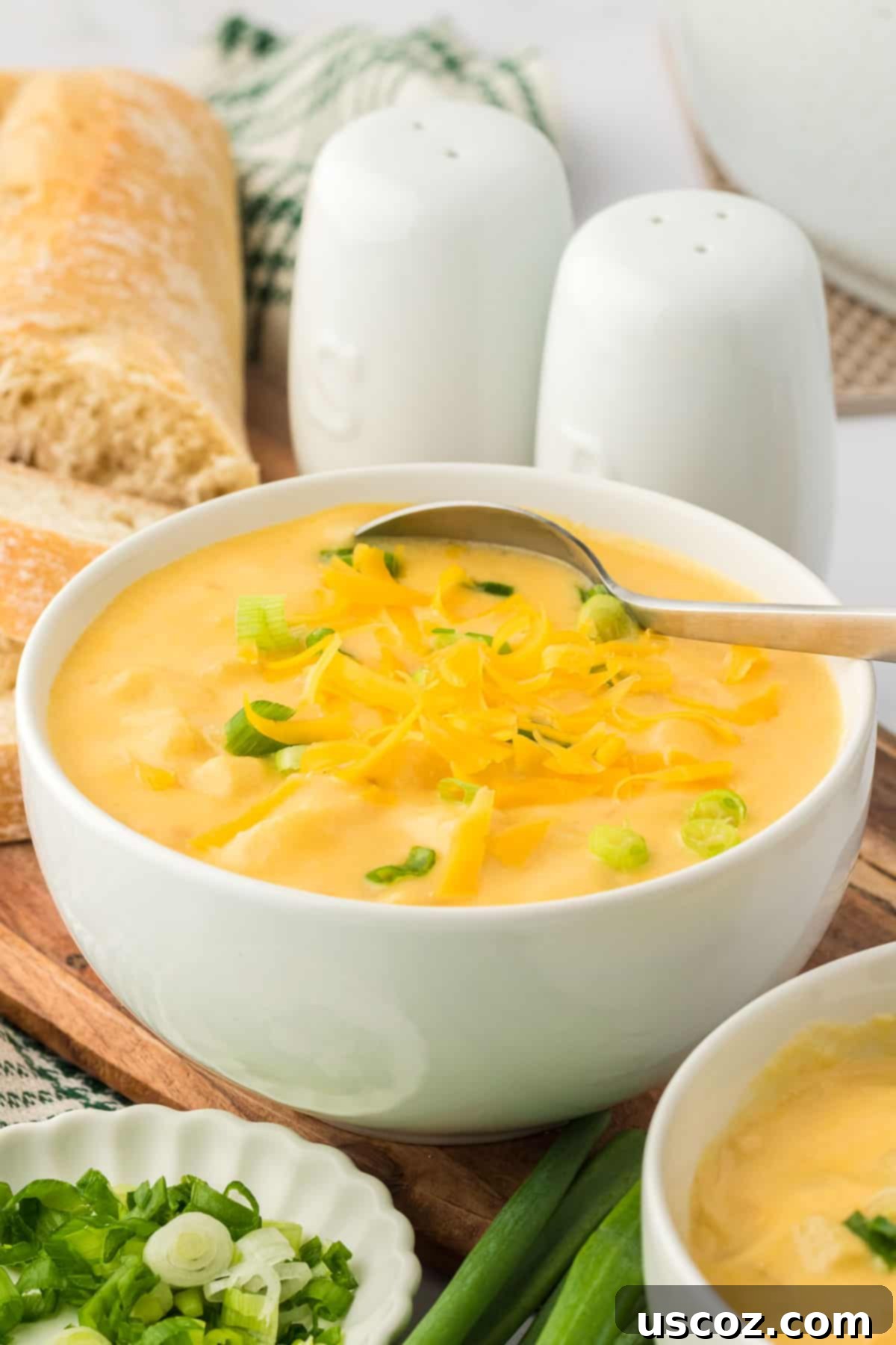 Hearty Potato Comfort 19 Another enticing view of a bowl of creamy potato soup, garnished with green onions and cheddar cheese.
