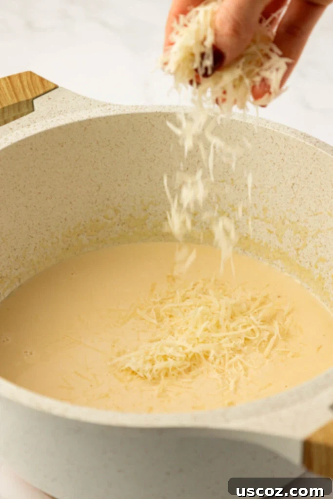 Farfalle 11 adding parmesan cheese to the sauce