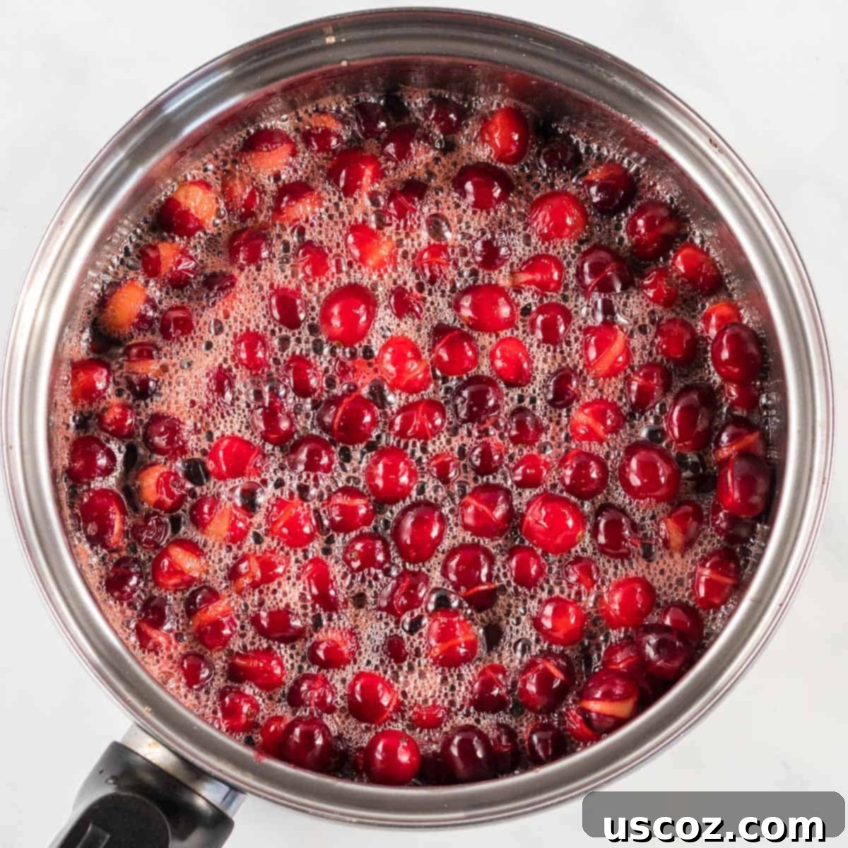 Perfect Homemade Cranberry Sauce 5 Bubbling cranberry sauce in a saucepan, showing the cranberries starting to burst