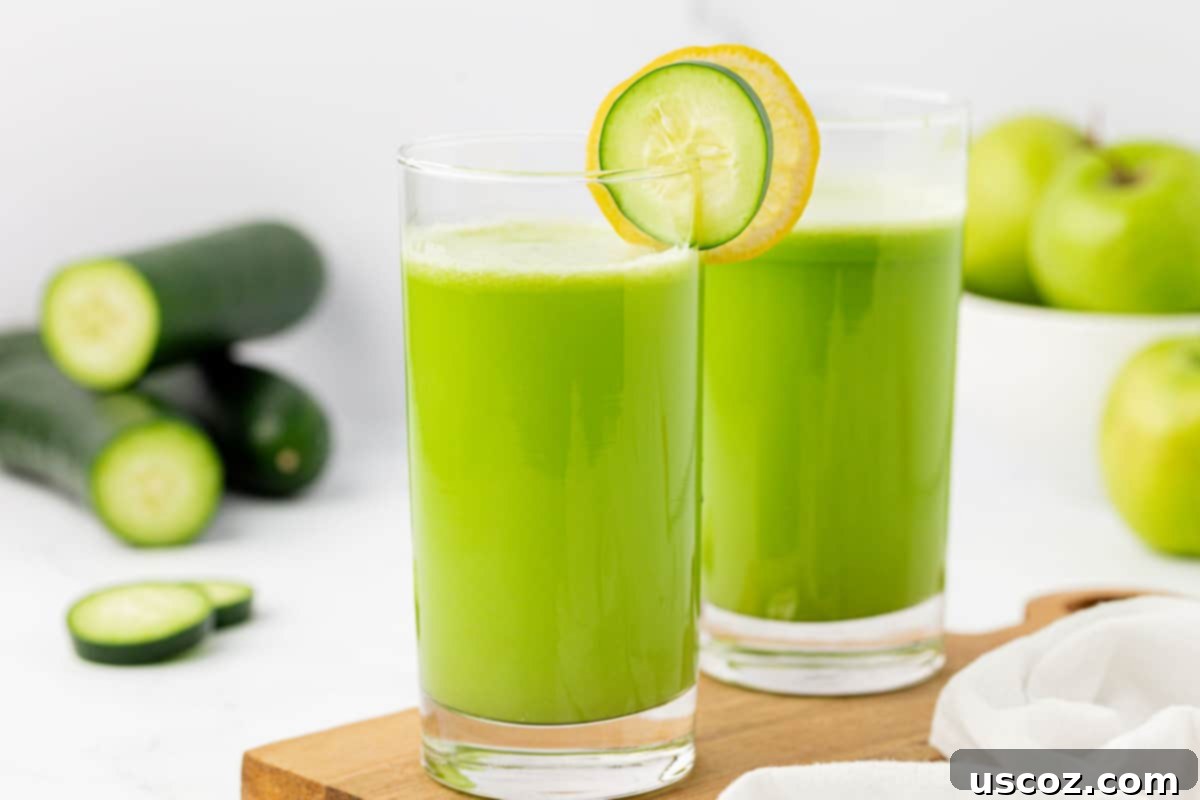 Cool Cucumber Elixir 11 juice in a glass with a cucumber and lemon slice on the rim