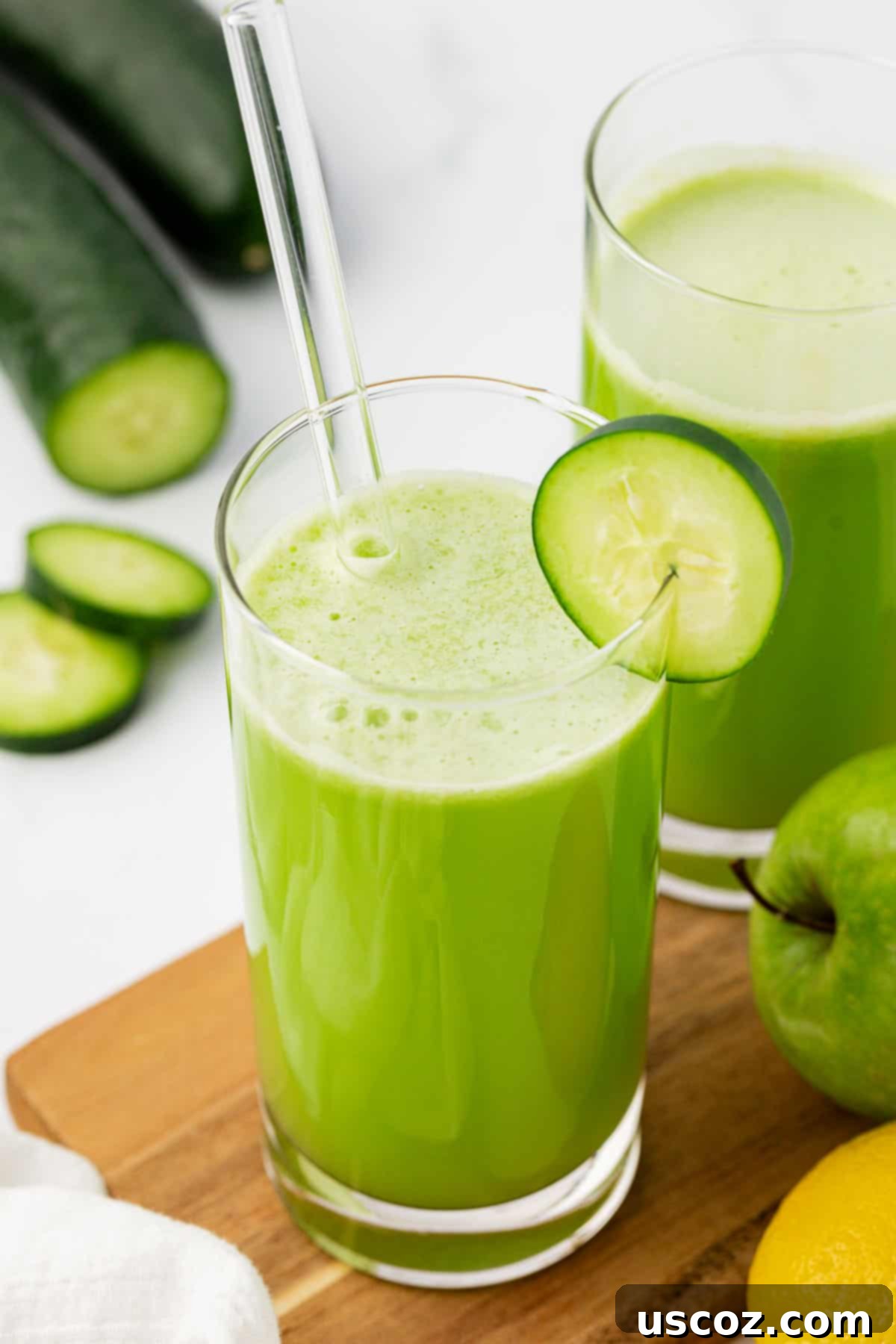 Cool Cucumber Elixir 8 juice in a glass with a cucumber slice on the rim