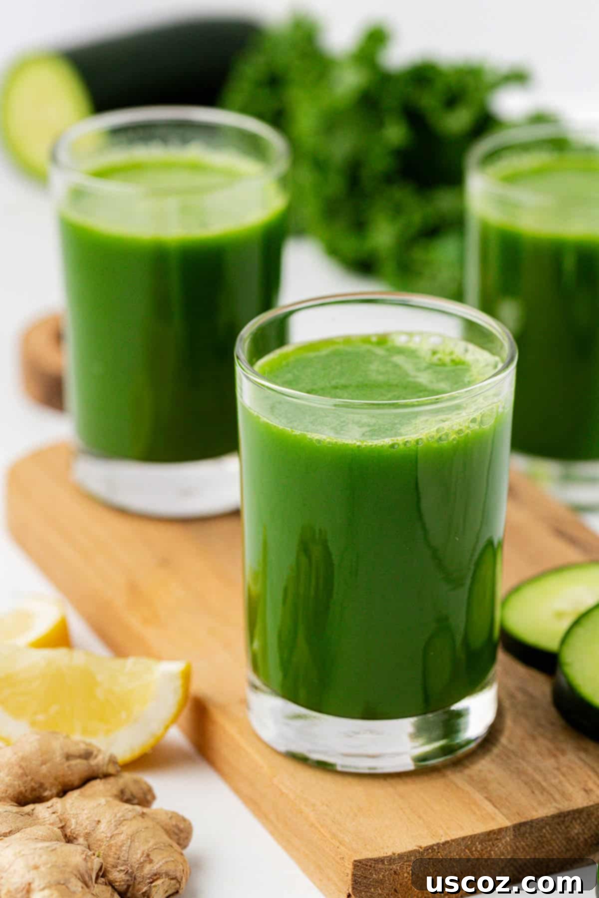 Emerald Elixir 2 Freshly made kale juice in a clear glass, ready to be enjoyed.