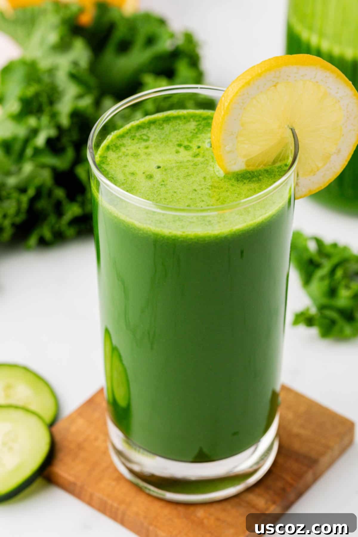 Emerald Elixir 11 A glass of kale juice garnished with a fresh lemon slice on the rim, highlighting its refreshing quality.