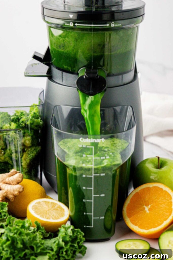 Emerald Elixir 5 Vibrant green kale juice flowing from the juicer's spout into a collection container.