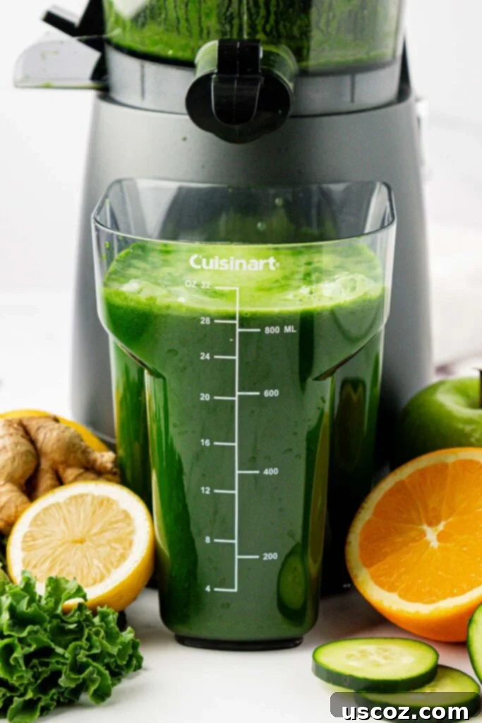 Emerald Elixir 6 Close-up of fresh kale juice collecting in the juicing canister, showing its rich green color.