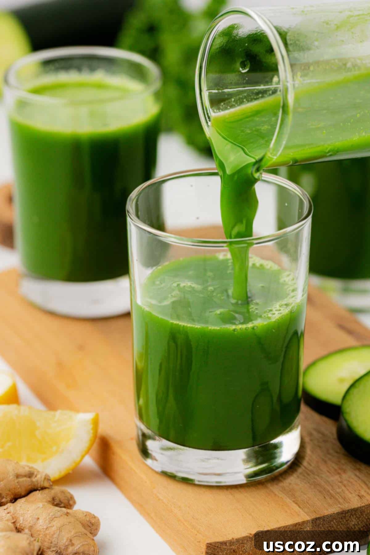 Emerald Elixir 7 Hand pouring vibrant green kale juice from a juicing container into a clear drinking glass.
