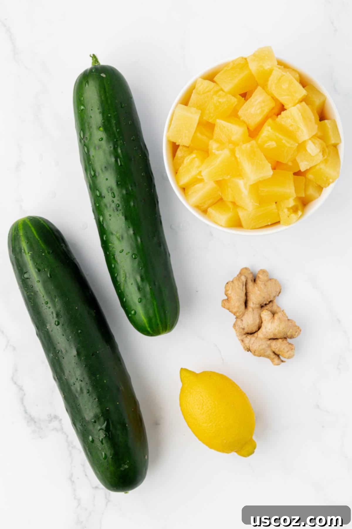 Hydrating Pineapple Cucumber Quencher 4 two cucumbers, lemon, pineapple chunks, and ginger