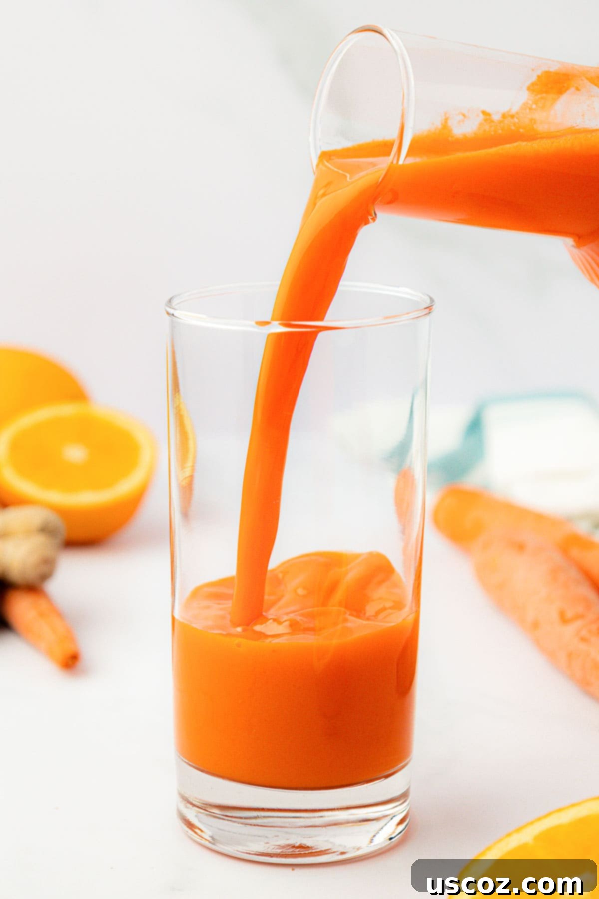 Vibrant Carrot Elixir 7 pouring carrot juice into a glass