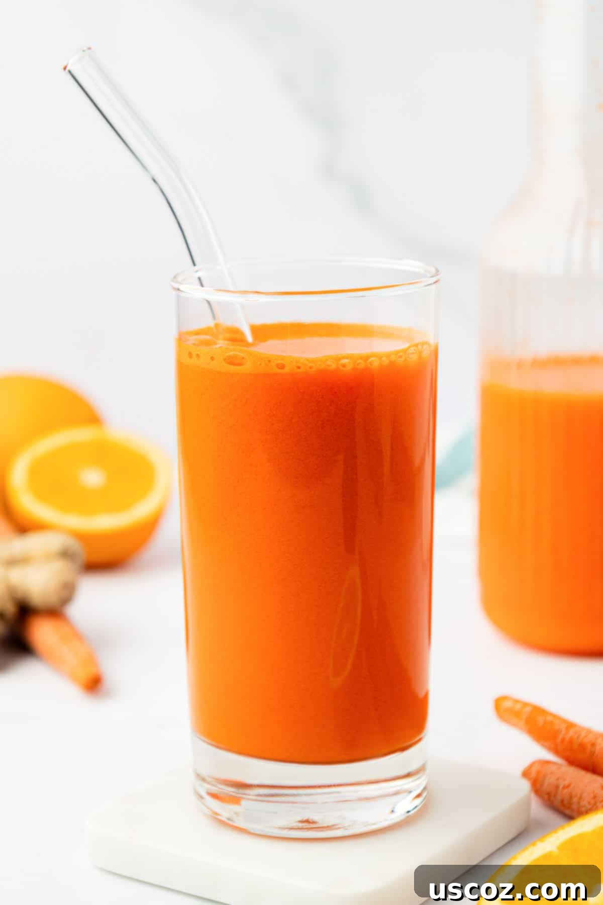 Vibrant Carrot Elixir 9 carrot juice in a glass with a straw