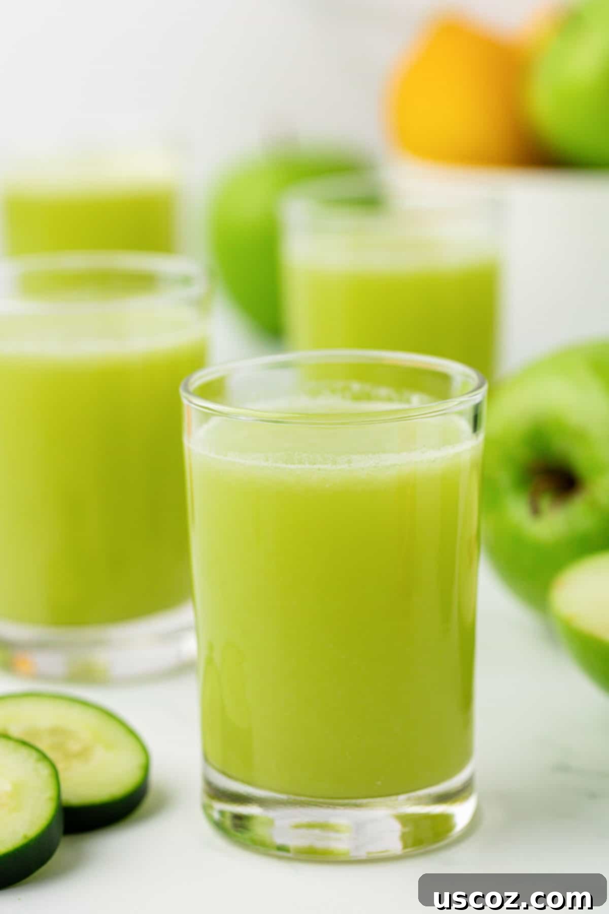 Emerald Zest Drink 2 Vibrant green apple juice served in a clear glass, inviting and fresh.