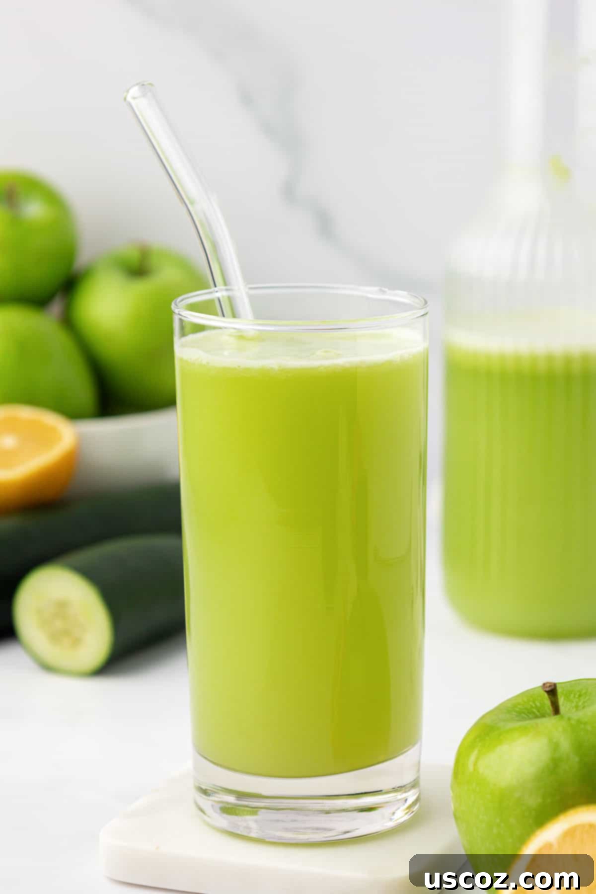 Emerald Zest Drink 11 Green apple juice in a tall glass with a reusable straw, ready to drink.