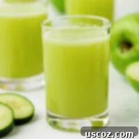 Emerald Zest Drink 12 Freshly pressed green apple juice in a glass, ready to drink.