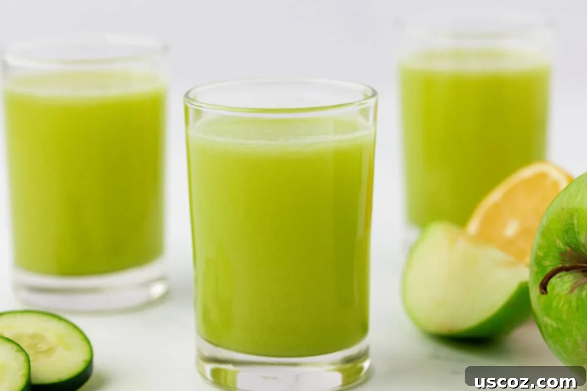 Emerald Zest Drink 3 Two glasses filled with fresh green apple juice, ready to be enjoyed.