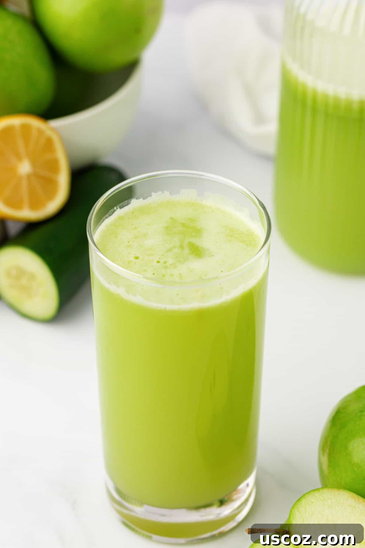 Emerald Zest Drink 10 A tall glass of green apple juice, beautifully presented.