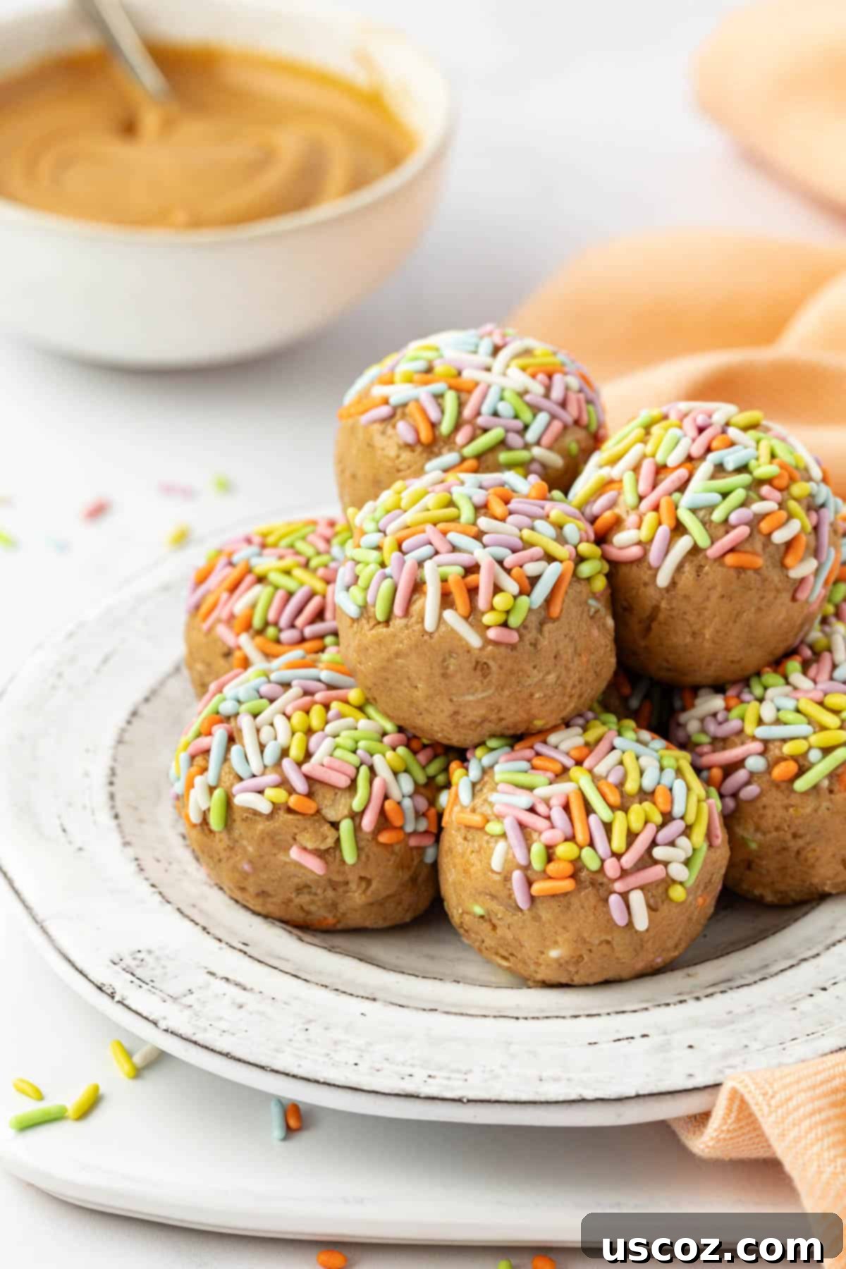 Funfetti Protein Bites 2 A top-down view of Birthday Cake Protein Balls arranged on a light surface, showing colorful sprinkles.