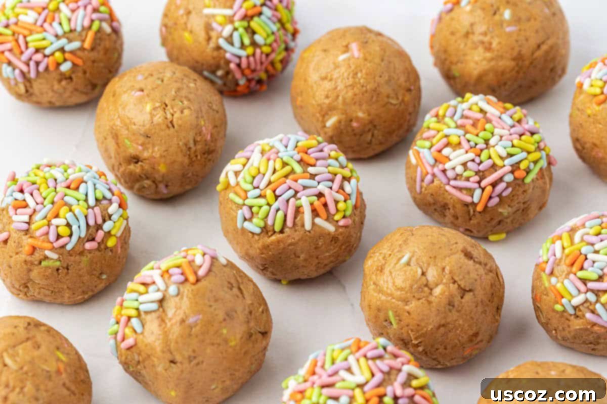 Funfetti Protein Bites 11 Several Birthday Cake Protein Balls scattered with colorful sprinkles on a surface.
