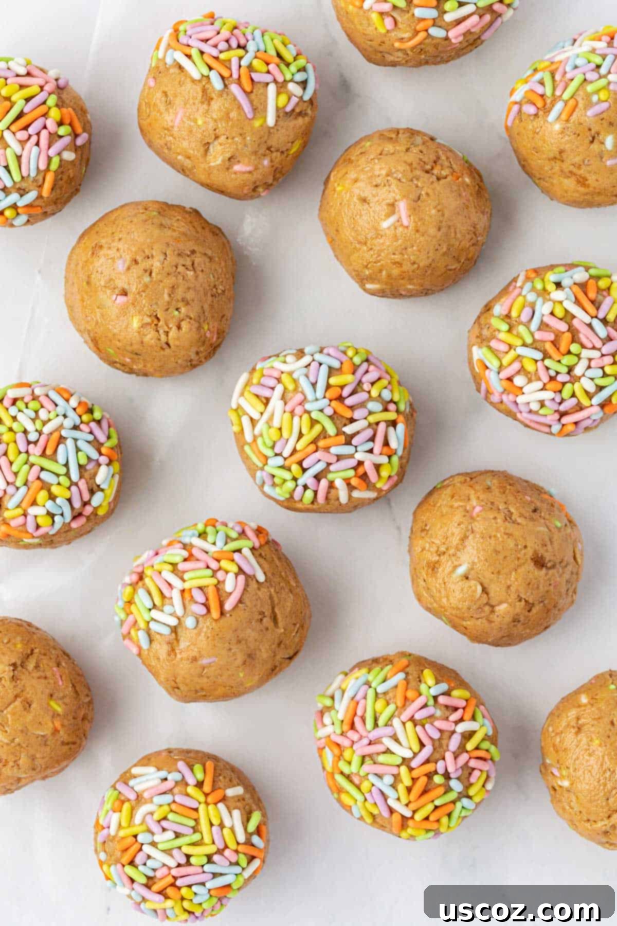 Funfetti Protein Bites 12 A stack of Birthday Cake Protein Balls with sprinkles, on a small wooden plate.