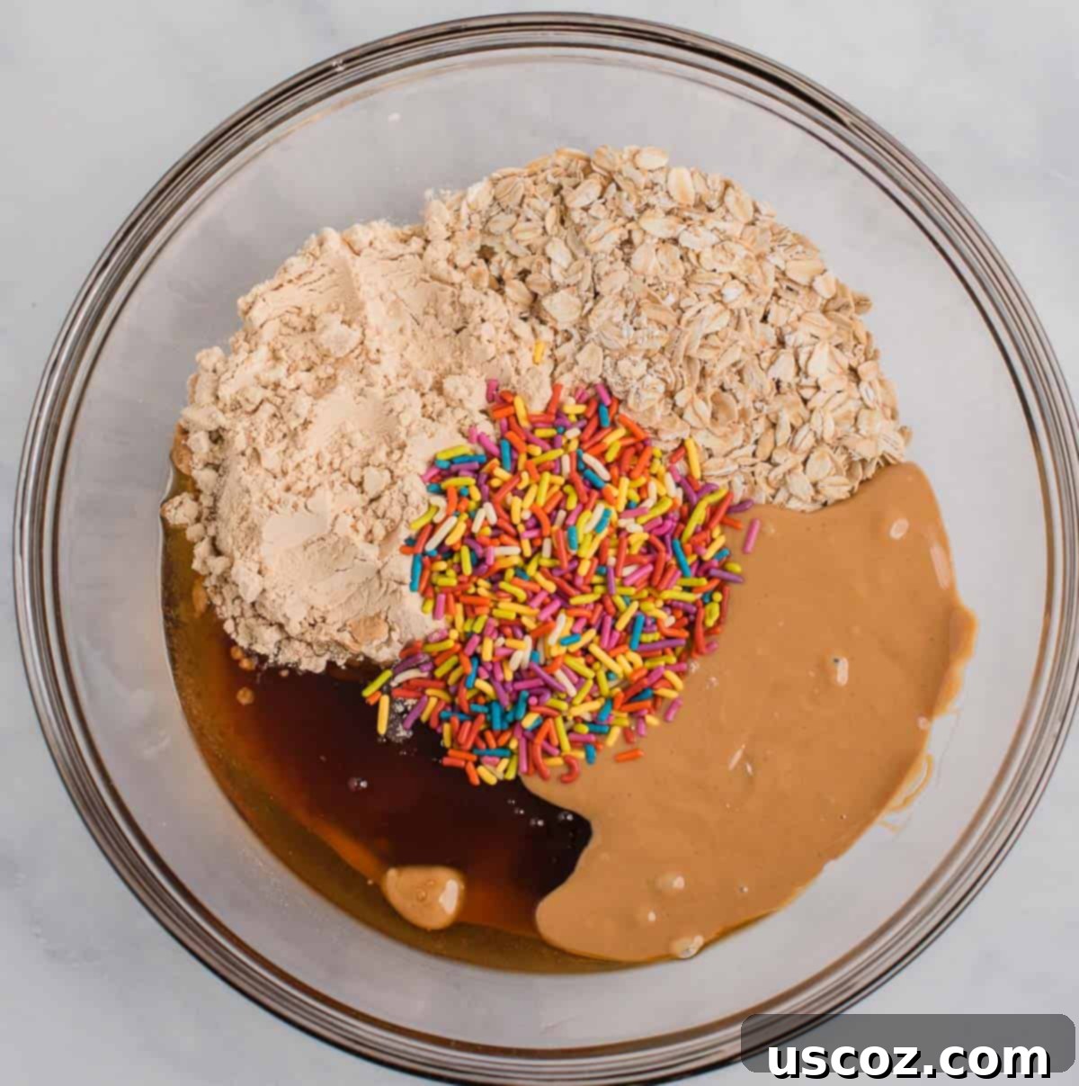 Funfetti Protein Bites 5 All ingredients for protein balls in a mixing bowl before combining.