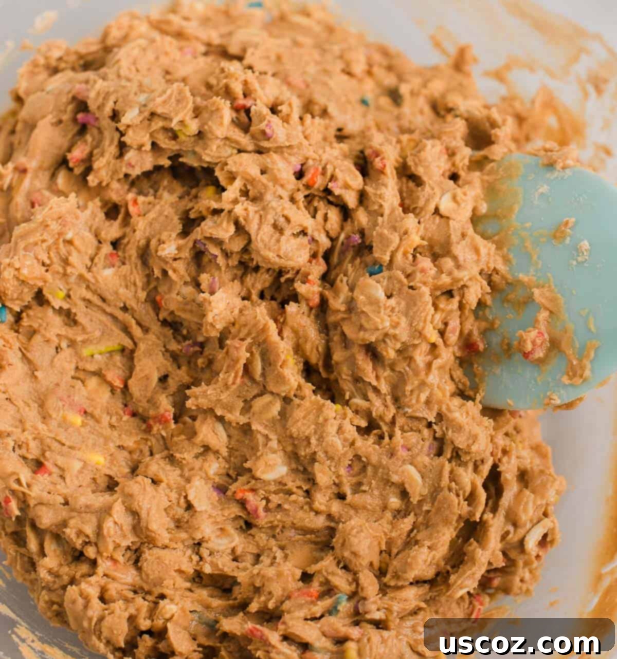 Funfetti Protein Bites 6 Mixed birthday cake protein ball batter in a bowl, resembling cookie dough.