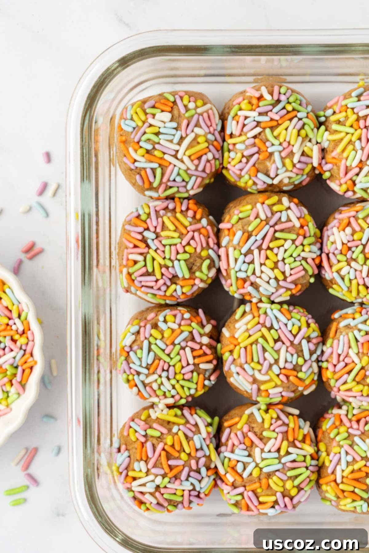 Funfetti Protein Bites 8 Hands rolling a protein ball and dipping it into a bowl of sprinkles.
