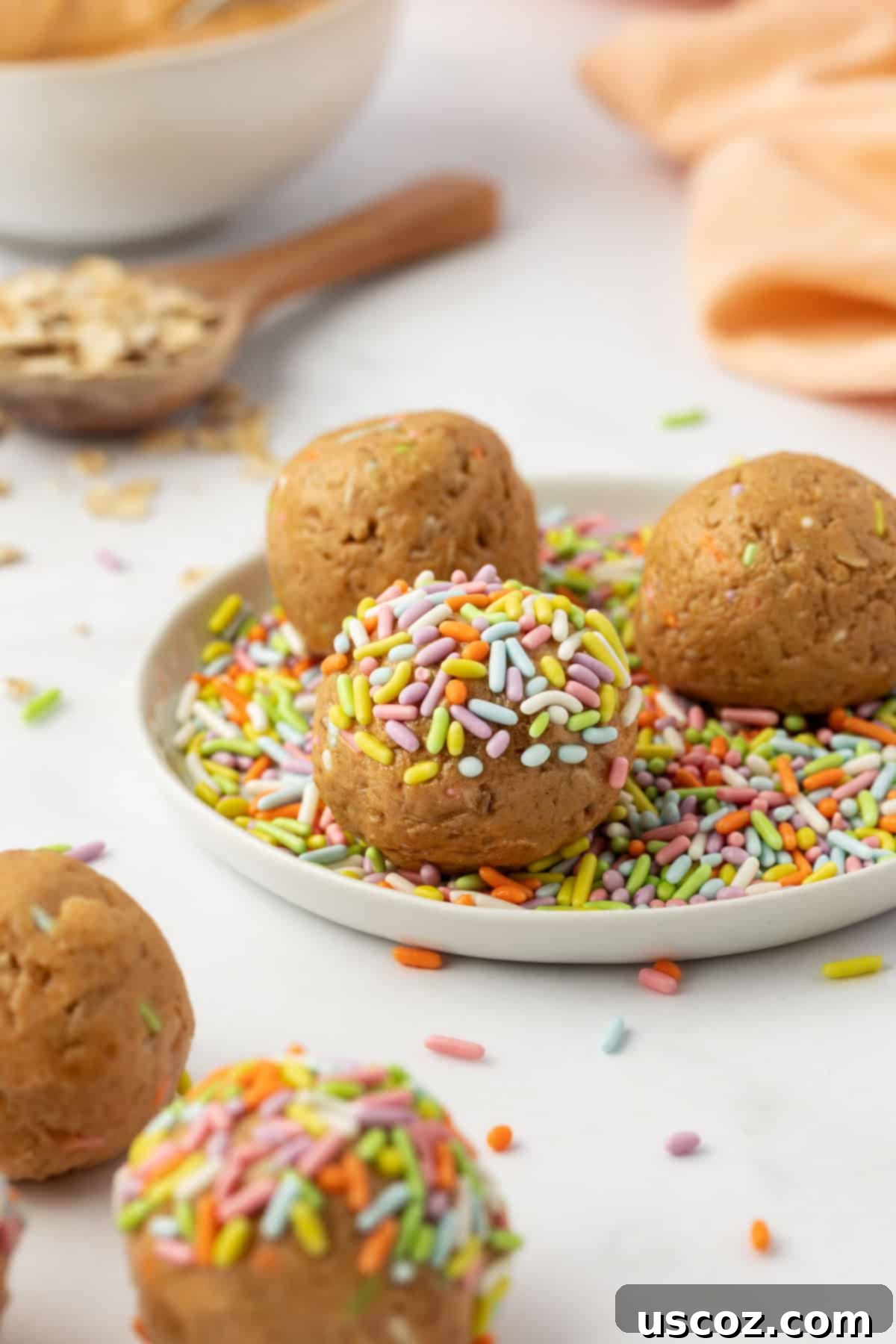 Funfetti Protein Bites 9 A stack of Birthday Cake Protein Balls in a bowl, showing their texture and colorful sprinkles.
