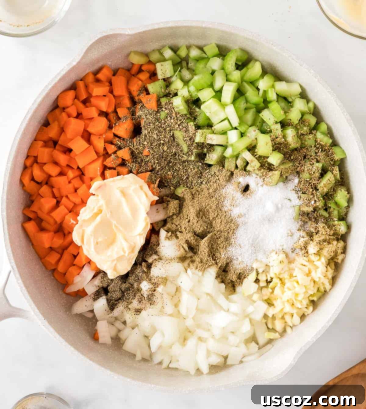 Adding vegan butter and aromatic spices to the vegetables in a skillet for vegan stuffing