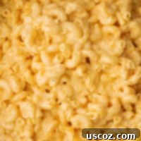 Creamy Slow Cooker Mac and Cheese 17 Creamy crock pot mac and cheese in a white bowl, ready to eat