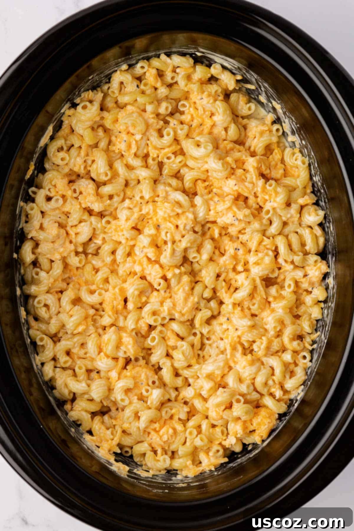 Creamy Slow Cooker Mac and Cheese 7 All ingredients for crock pot mac and cheese mixed together in a slow cooker before cooking
