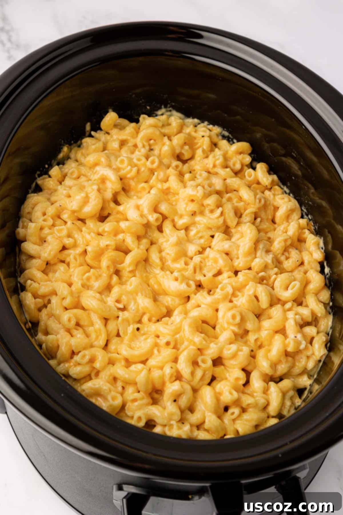 Creamy Slow Cooker Mac and Cheese 10 Cooked macaroni and cheese in a crock pot, cheese melted and creamy